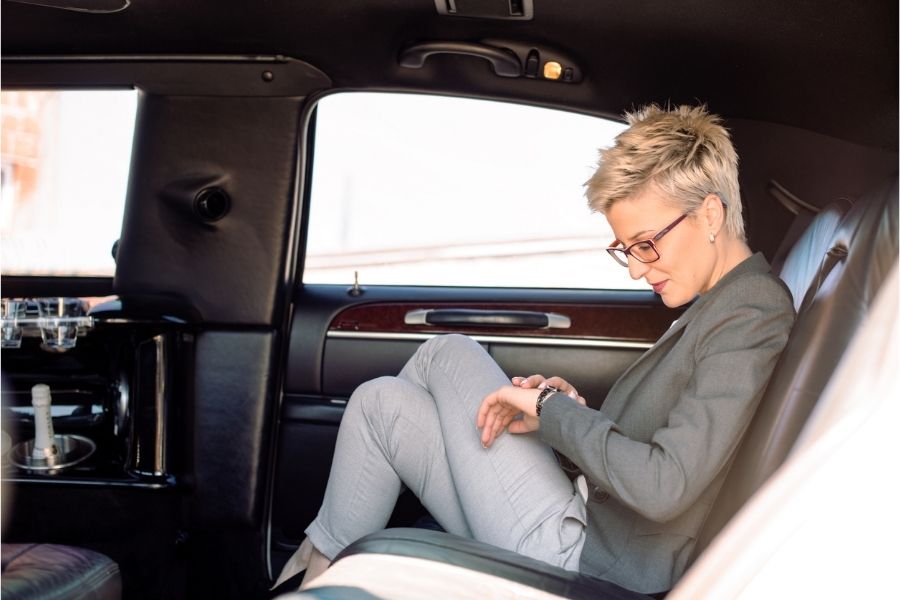 A Business Woman Sitting in Liomousine